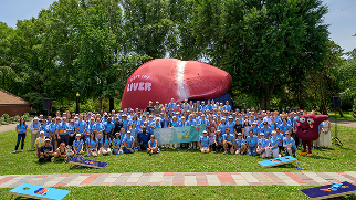 Large group of attendees pose in front of the giant inflatable liver at the MASH Across America launch event in Philadelphia