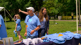 Attendees browse the event merchandise table