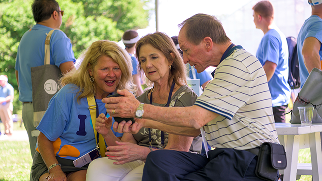 Three attendees gather together, engaged in conversation